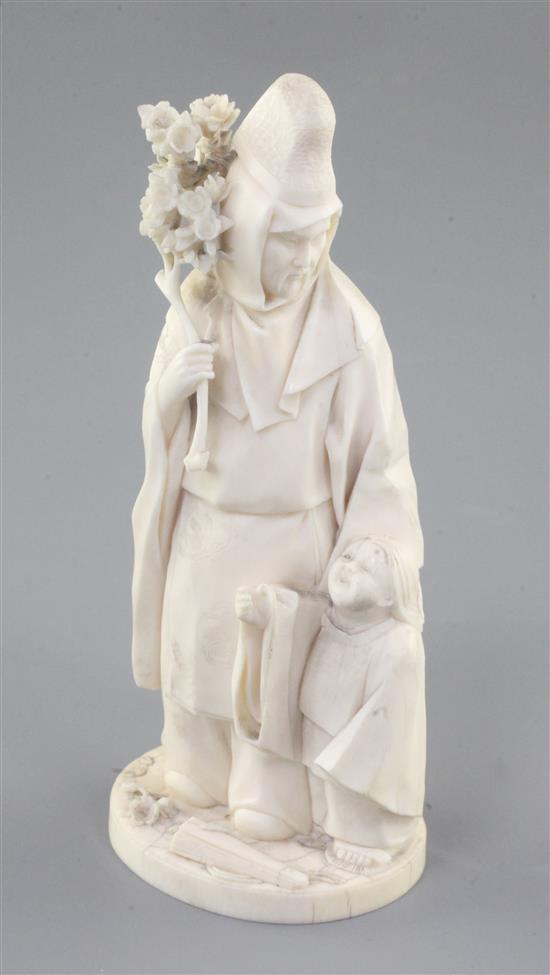A Japanese ivory okimono of priest and a child, Meiji period,